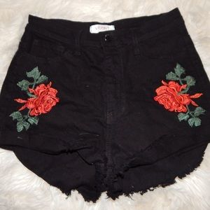 Black high waisted shorts with rose embellishments